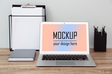 Image of Modern laptop with text Mockup Your Design Here on screen