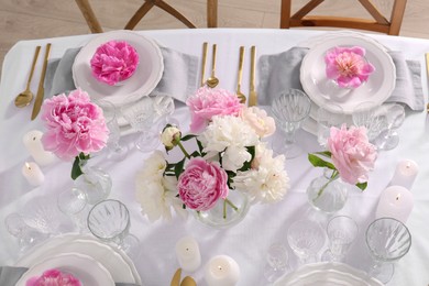 Stylish table setting with beautiful peonies in dining room