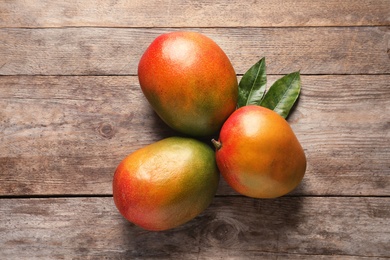 Flat lay composition with mango on wooden background