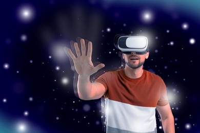 Image of Innovation idea. Man exploring space using VR headset. Lights and blue gradient background as cosmos around him symbolizing digital reality