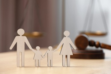 Photo of Family law. Figure of parents with children and gavel on wooden table, space for text