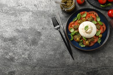 Photo of Delicious burrata salad served on grey table, flat lay. Space for text