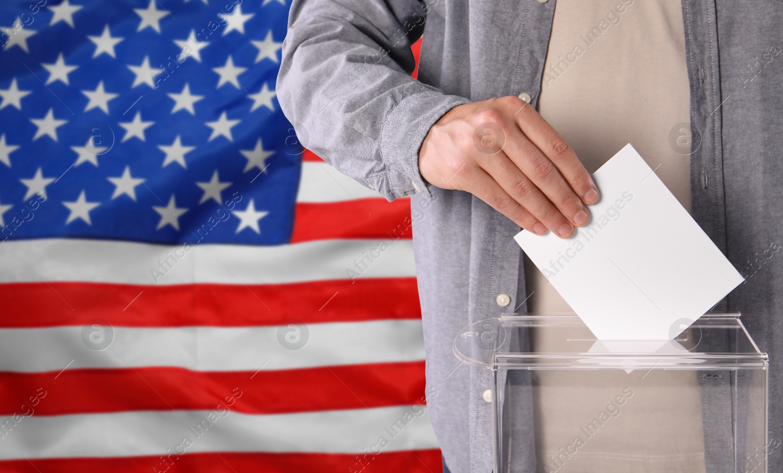 Image of Man putting his vote into ballot box against national flag of United States, closeup. Space for text