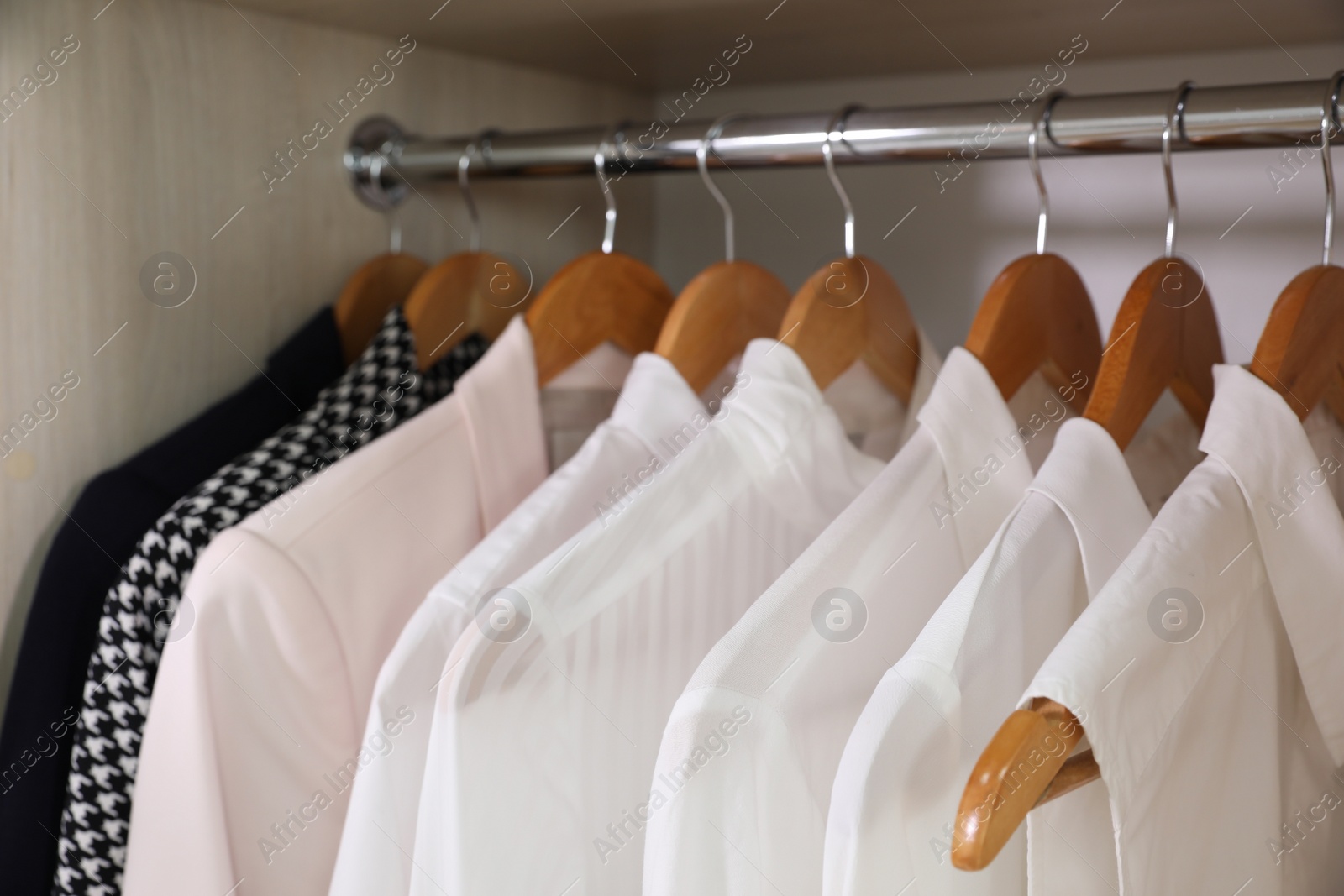 Photo of Wardrobe with different stylish clothes indoors, closeup