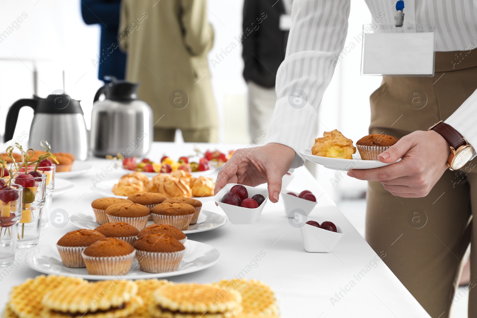 Photo of Woman taking snack during coffee break, closeup