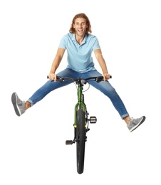 Photo of Happy young man riding bicycle on white background