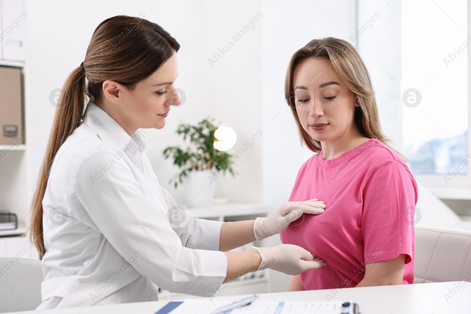 Photo of Mammologist checking young woman's breast in hospital