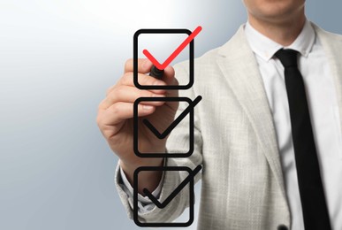 Image of Man pointing at red check mark in box on virtual screen, closeup