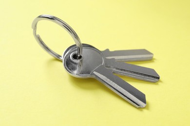 Keys with ring on yellow background, closeup