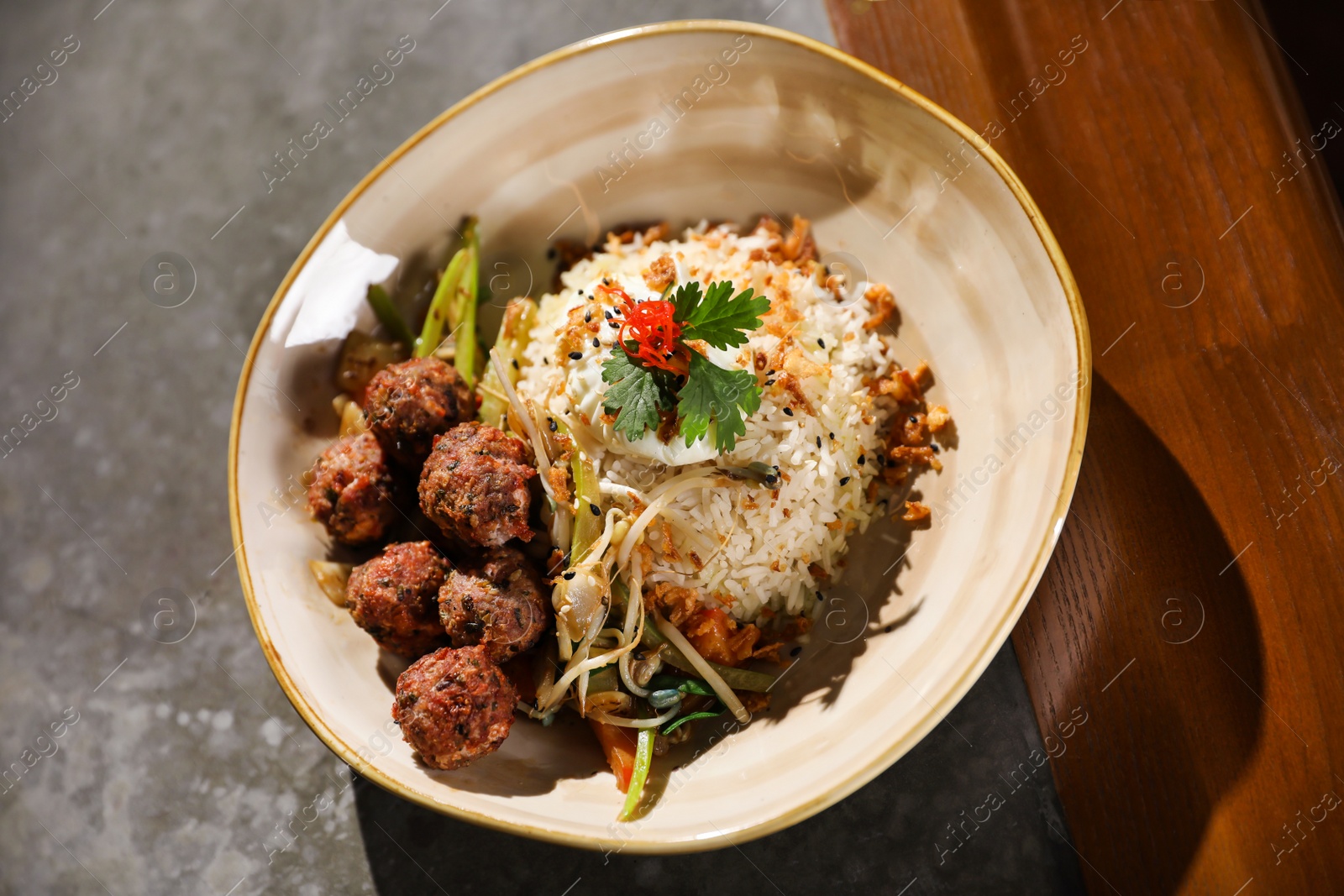 Photo of Plate with rice and meat balls served on table