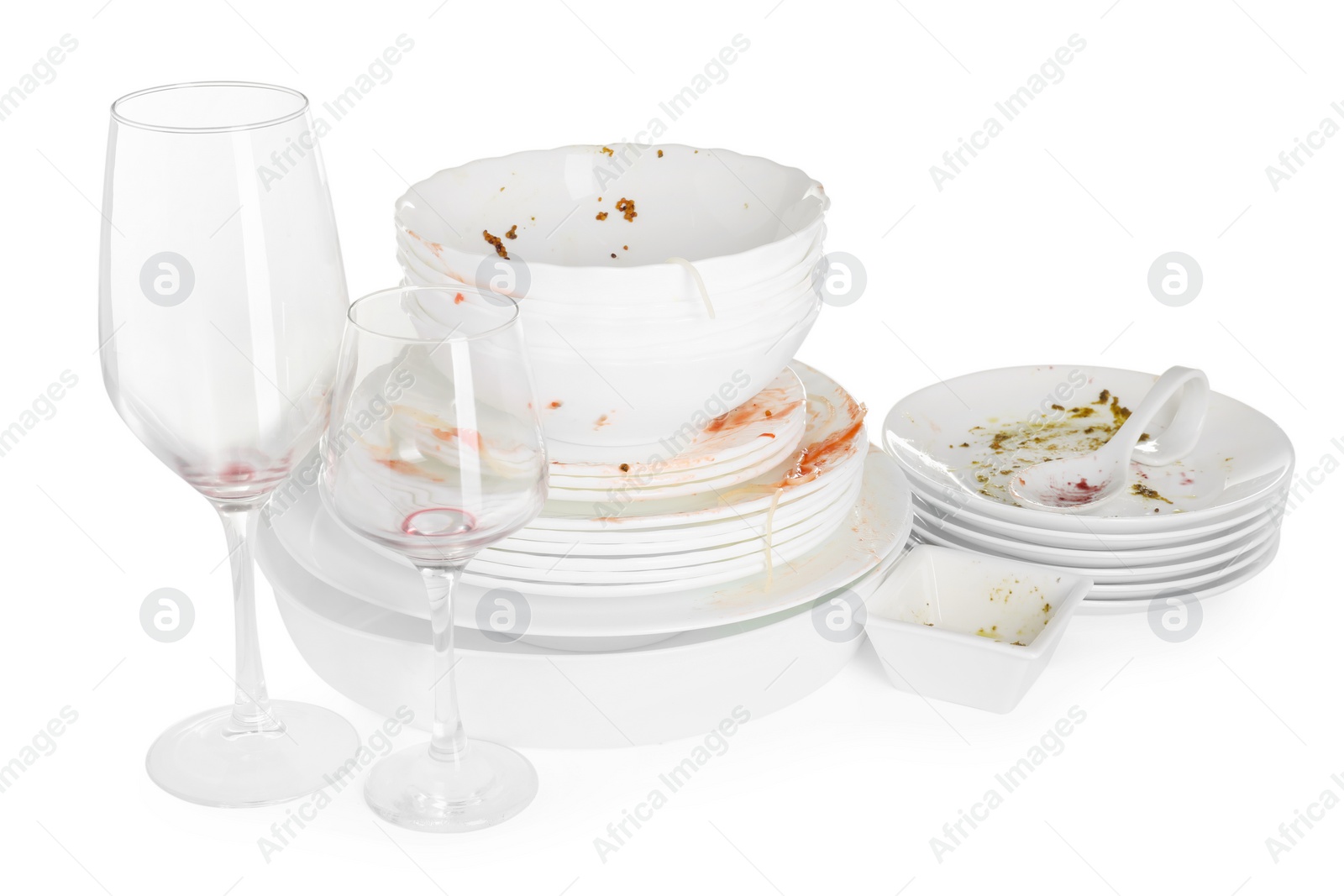 Photo of Many dirty dishes and glasses isolated on white