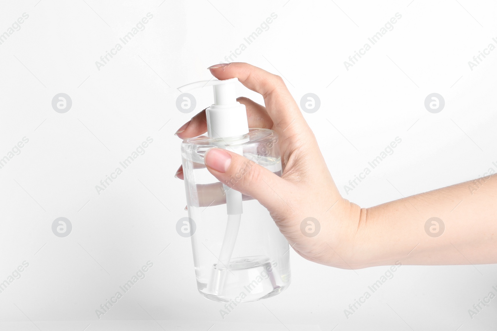 Photo of Woman holding antiseptic gel on white background, closeup