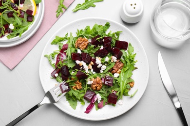 Photo of Delicious beet salad served on grey table, flat lay