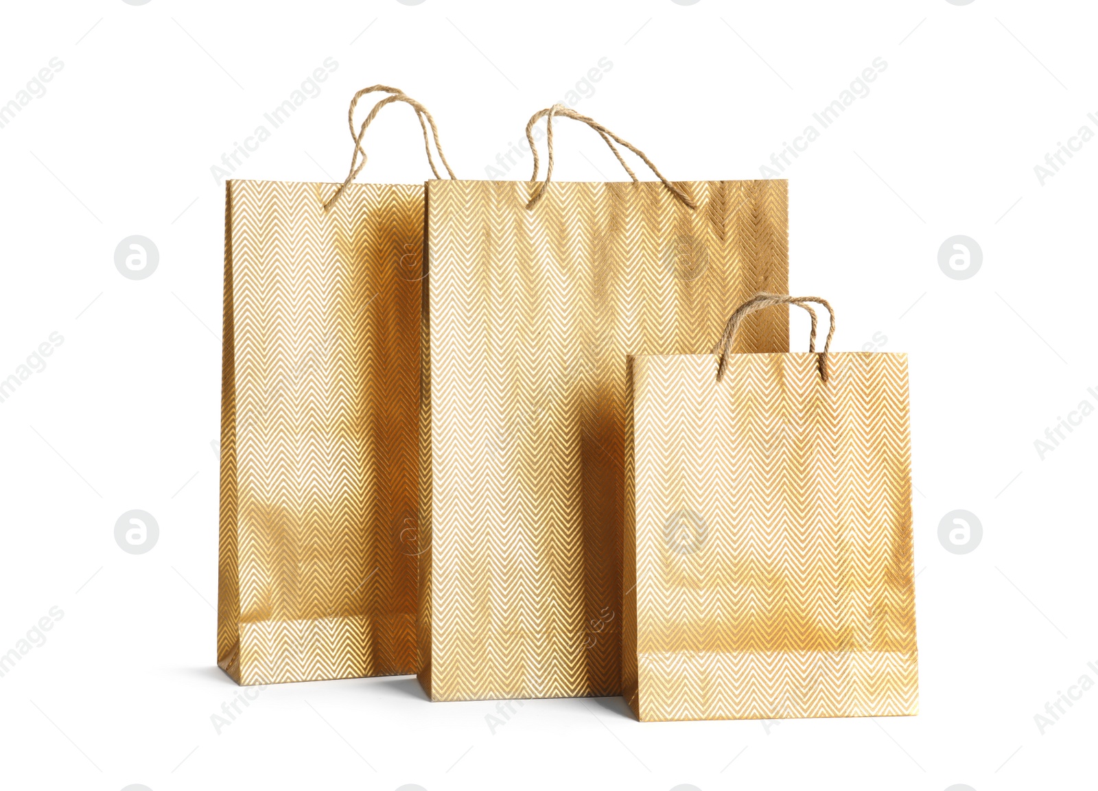 Photo of Golden paper shopping bags isolated on white. Space for design