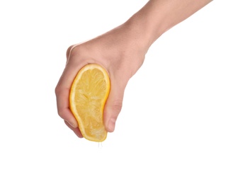 Woman squeezing fresh lemon juice isolated on white, closeup