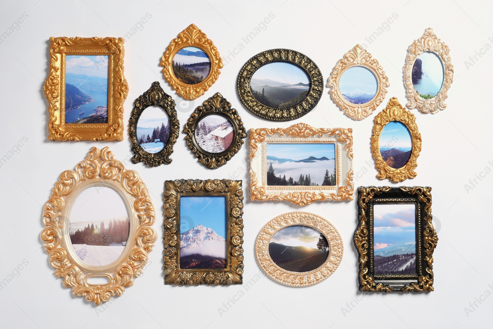 Photo of Vintage frames with photos of beautiful landscapes hanging on white wall