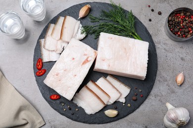 Pork fatback with spices served on grey table, flat lay