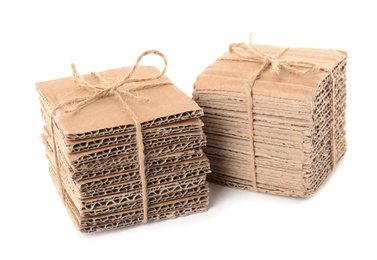 Photo of Stacks of cardboard pieces on white background. Recyclable material