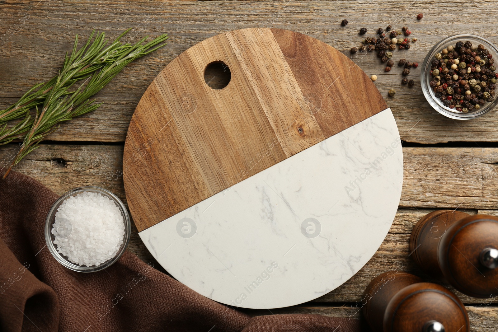 Photo of Cutting board and spices on old wooden table, flat lay