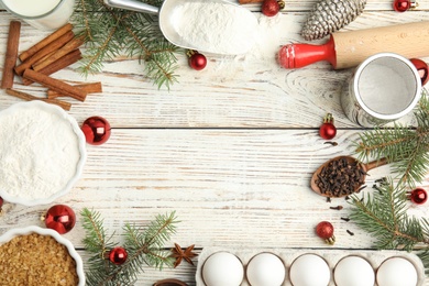 Photo of Flat lay composition with ingredients for traditional Christmas cake on white wooden table. Space for text