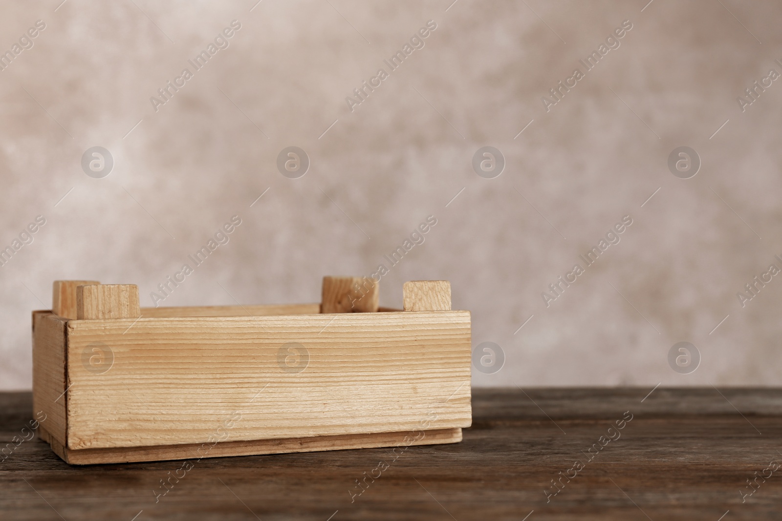 Photo of Wooden crate on table against color background. Space for text