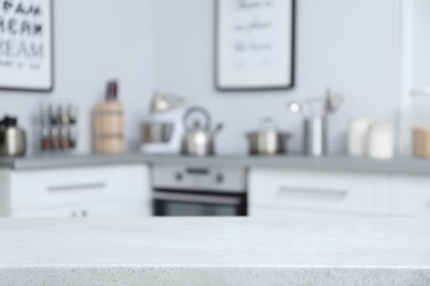 Photo of Empty table and blurred view of kitchen interior