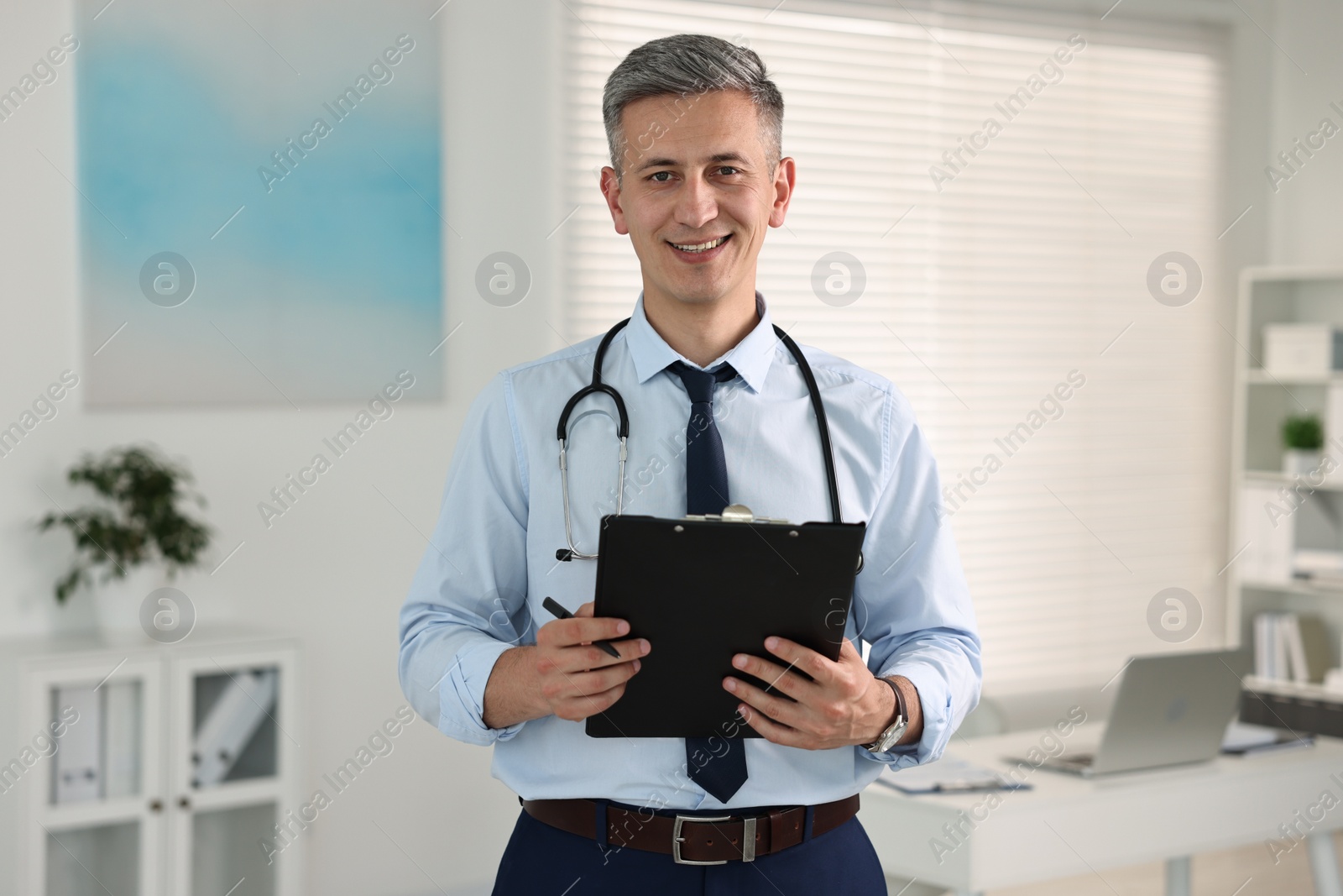 Photo of Doctor with stethoscope and clipboard in clinic