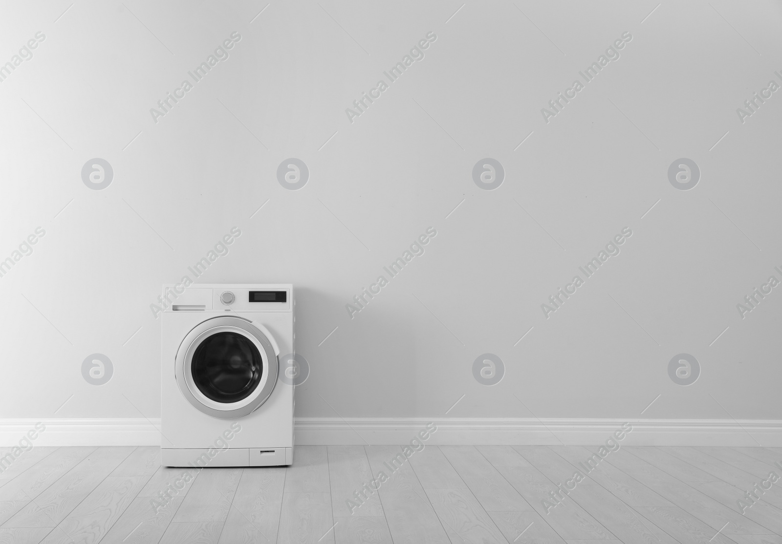 Photo of Washing machine near white wall, space for text. Laundry day