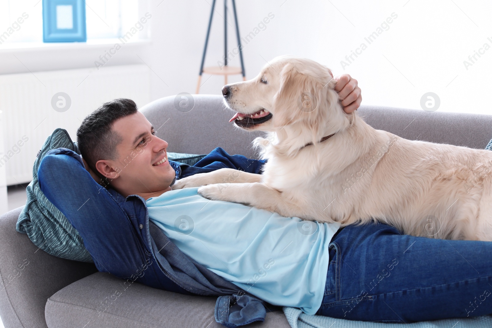 Photo of Portrait of owner with his friendly dog at home