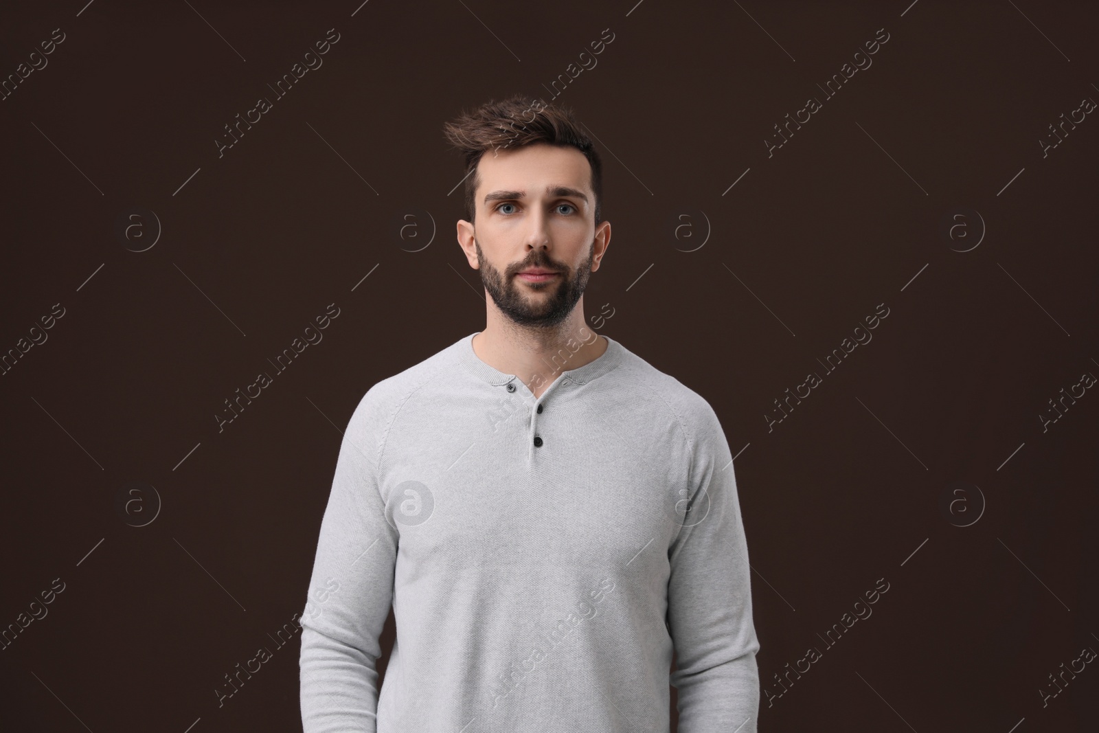 Photo of Portrait of handsome man on brown background