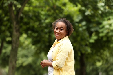 Photo of Portrait of happy African-American woman in park