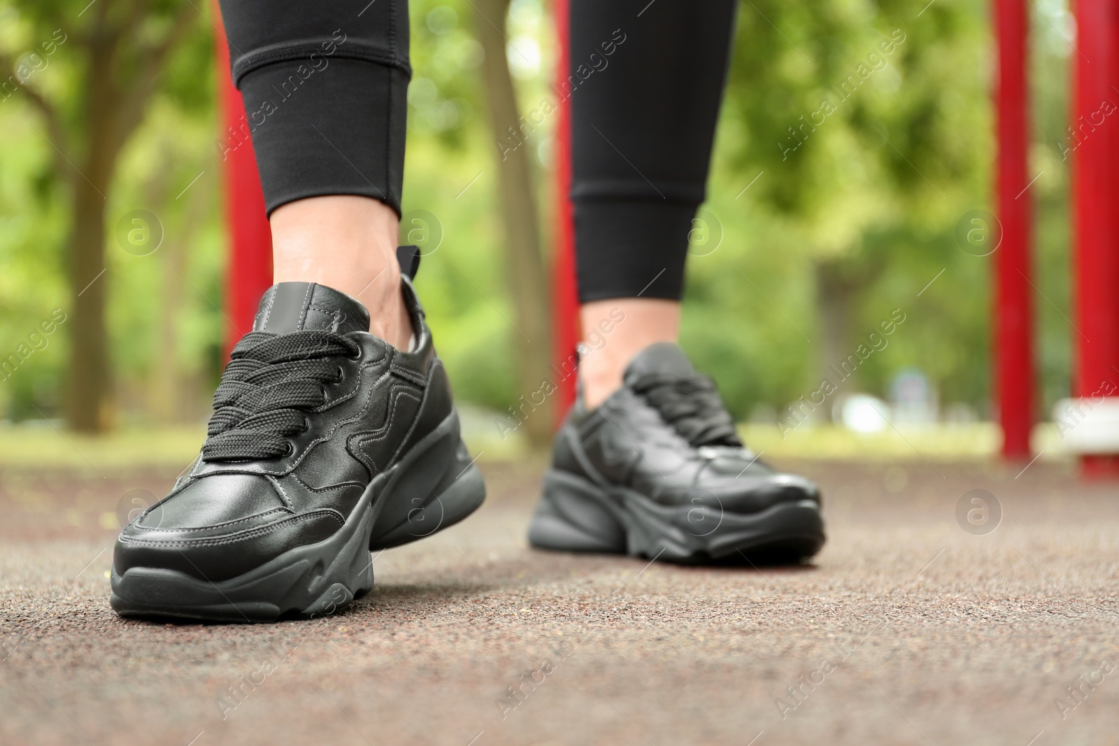 Photo of Woman in comfortable stylish sneakers outdoors, closeup