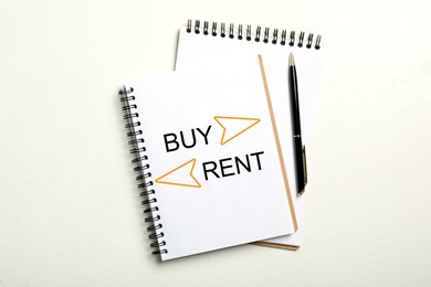 Image of Buy or rent - choice concept. Notebooks and pen on white background, flat lay