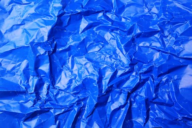 Photo of Sheet of crumpled blue paper as background, top view