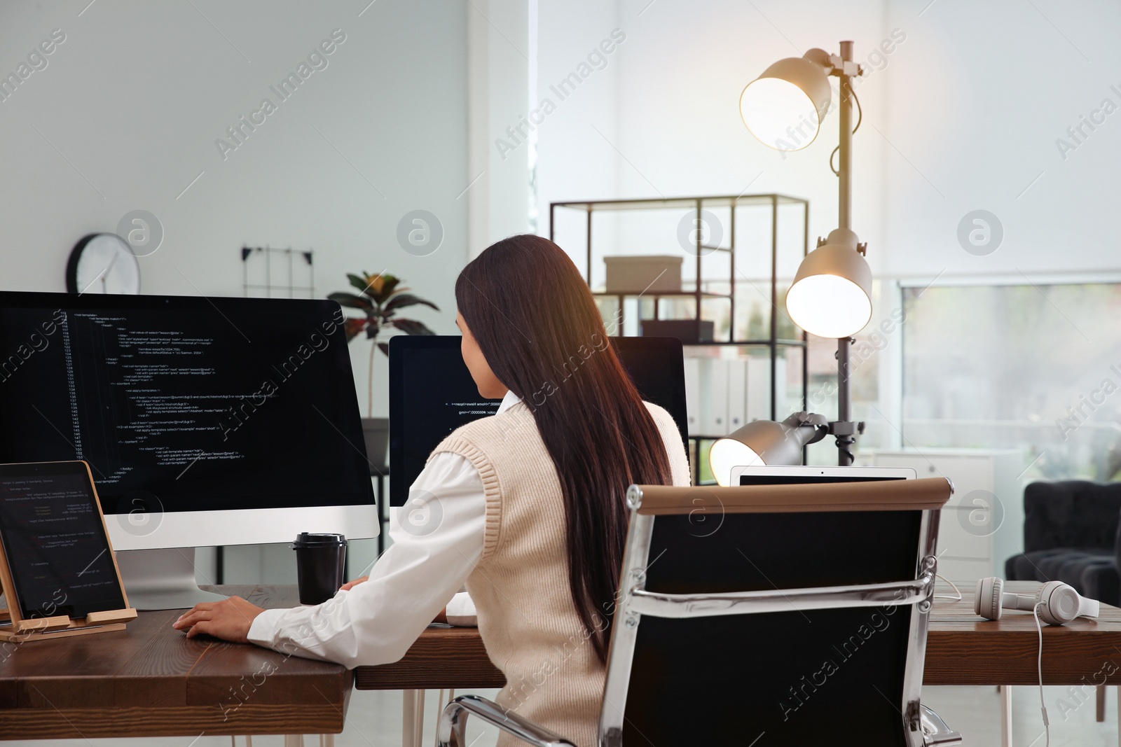 Photo of Programmer working at desk in modern office