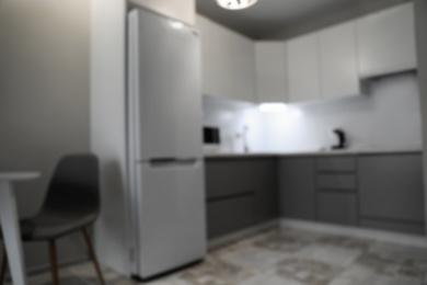 Photo of Blurred view of stylish modern kitchen interior