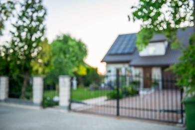 Blurred view of beautiful house behind fence