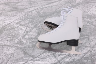 Pair of figure skates on ice, space for text