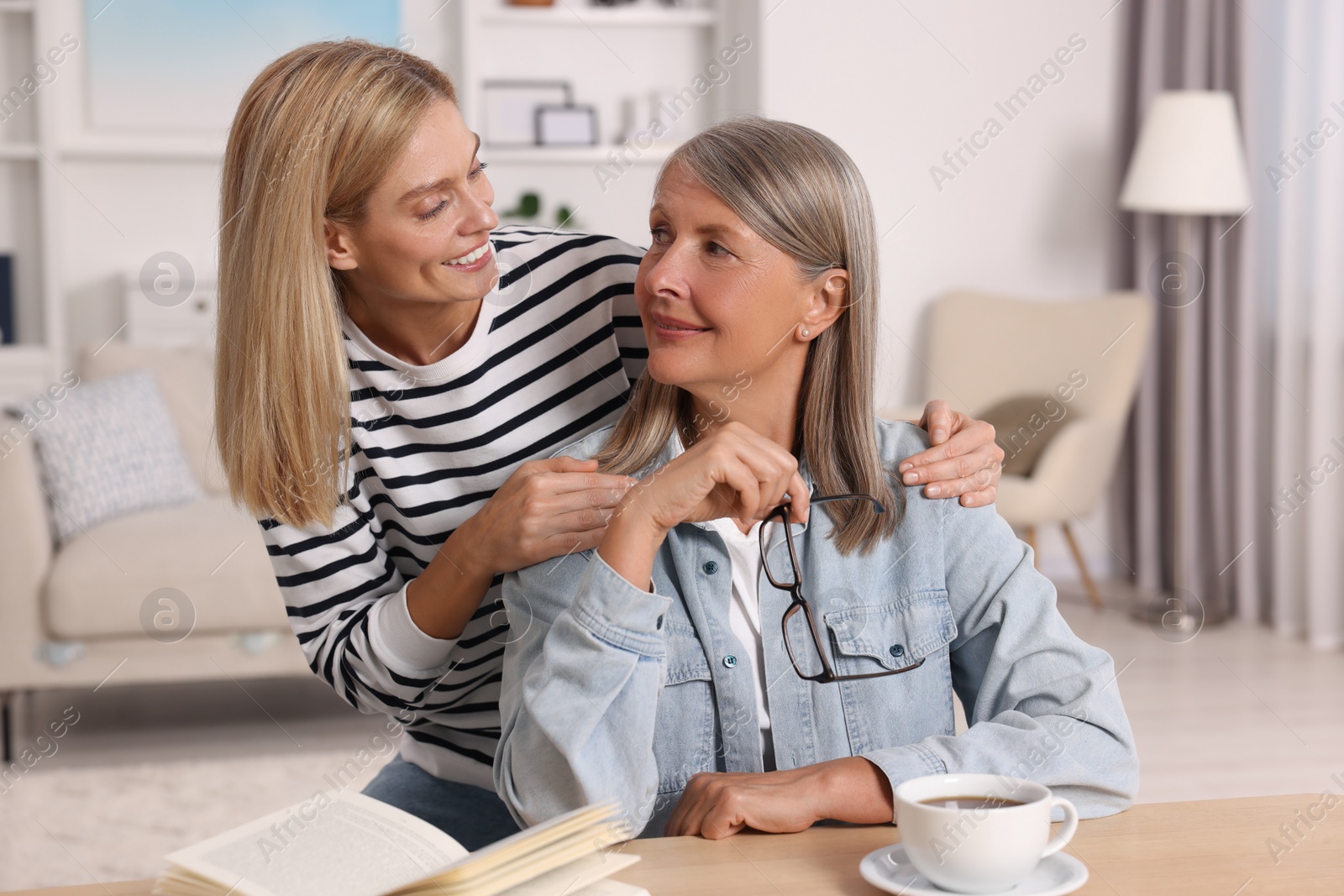 Photo of Happy mature mother and her daughter at home