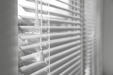 Photo of Stylish window with horizontal blinds indoors, closeup. Space for text