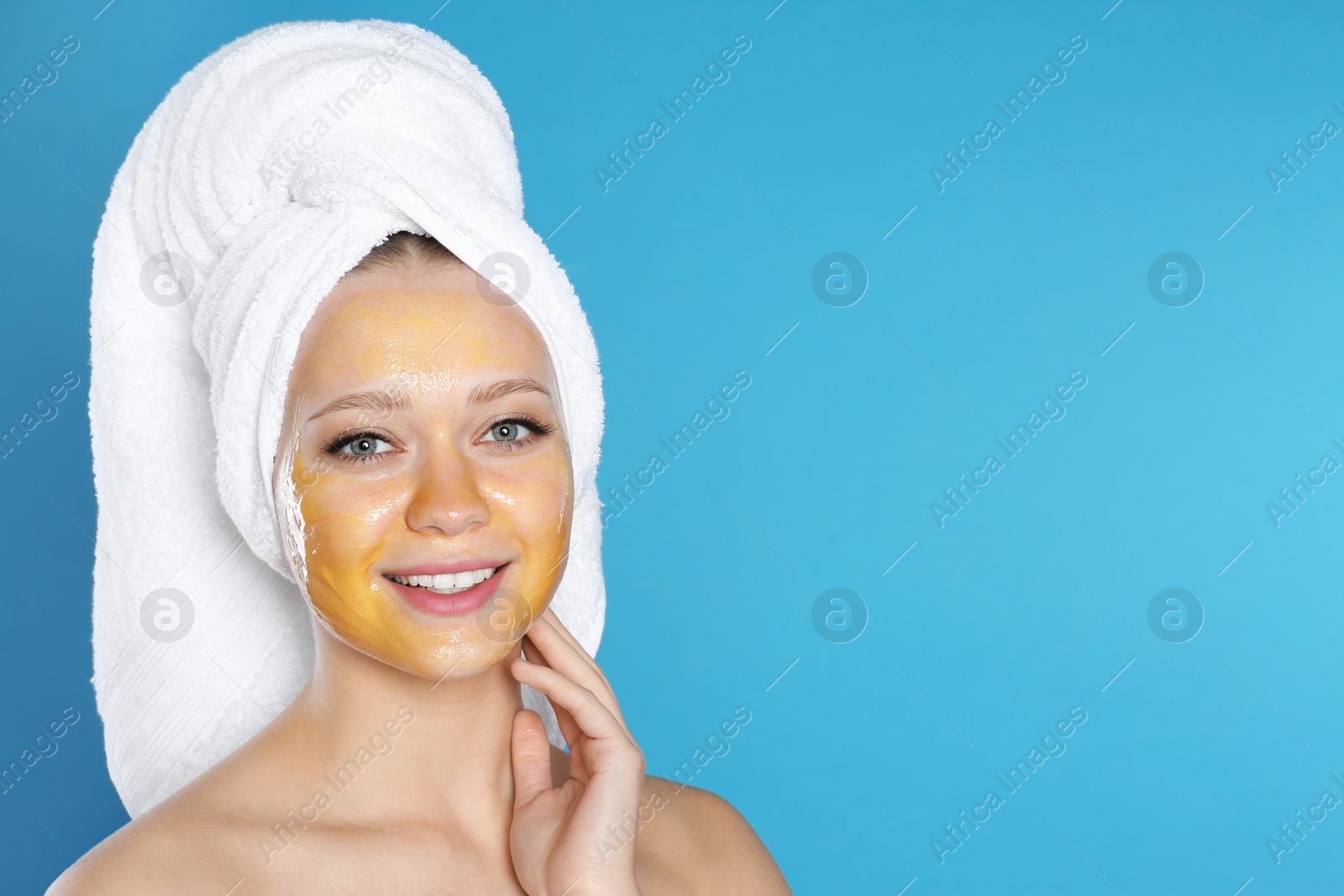 Photo of Beautiful woman with natural mask on her face against color background. Space for text