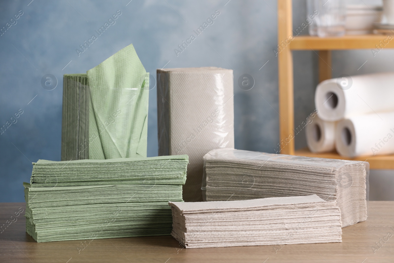 Photo of Many paper napkins on wooden table indoors