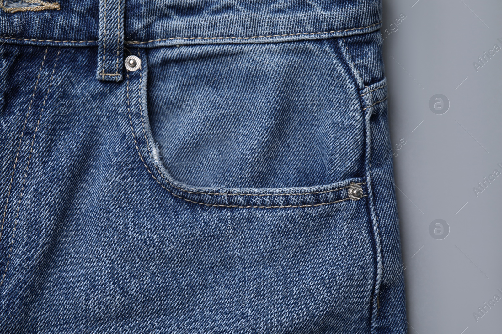 Photo of Jeans with pocket on light grey background, top view