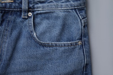 Photo of Jeans with pocket on light grey background, top view