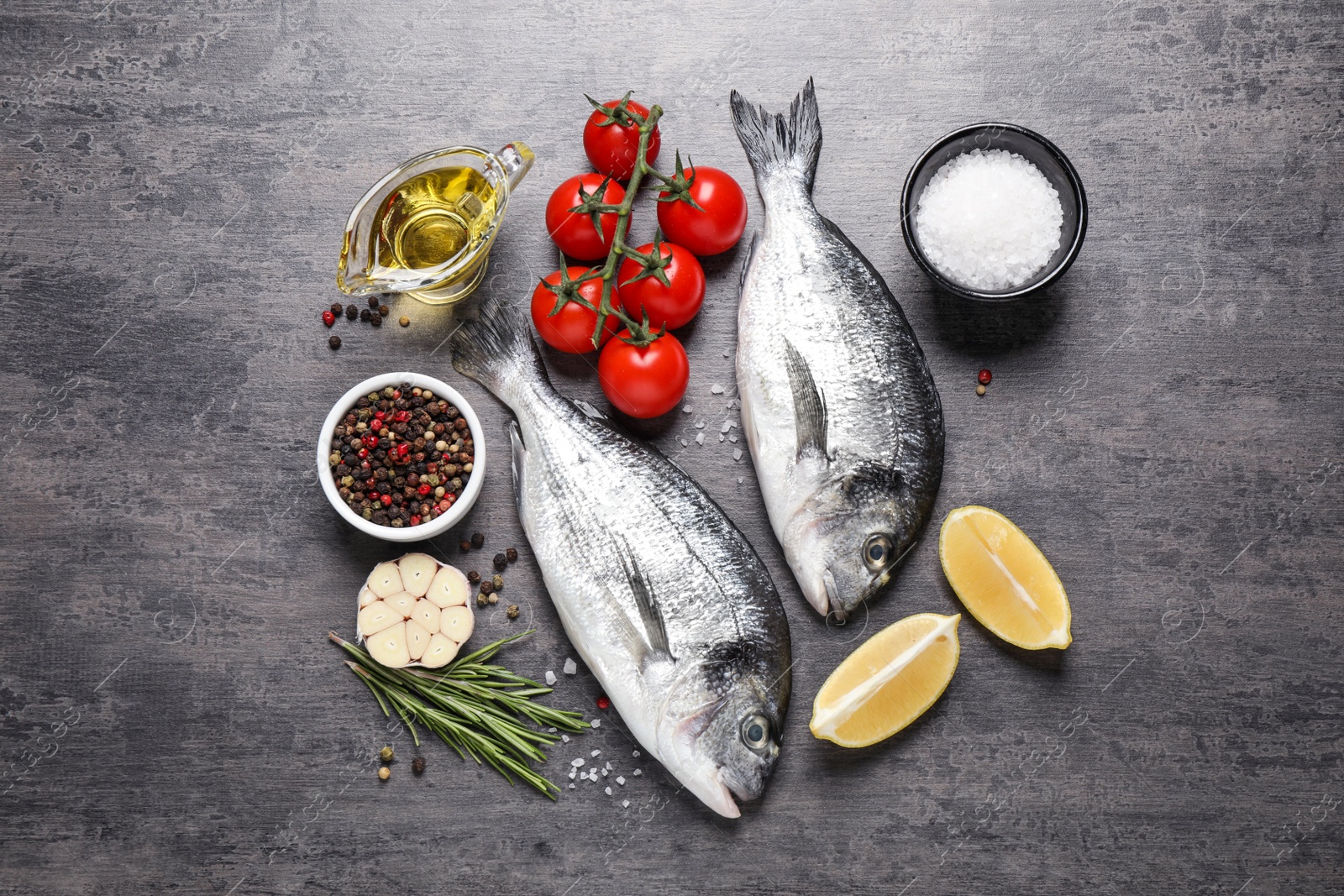 Photo of Flat lay composition with raw dorada fish on grey table