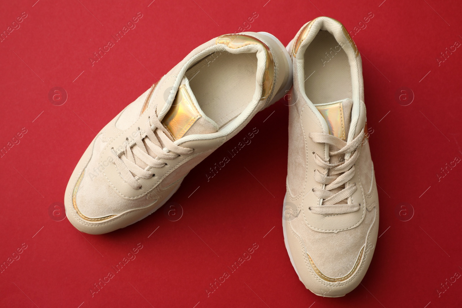 Photo of Pair of stylish shoes on red background, top view