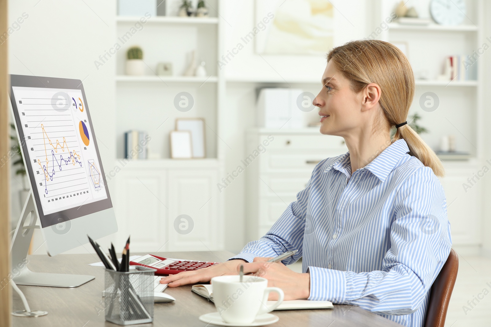 Photo of Professional accountant working at wooden desk in office