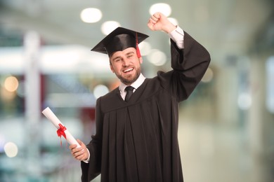 Image of Happy student with graduation hat and diploma indoors