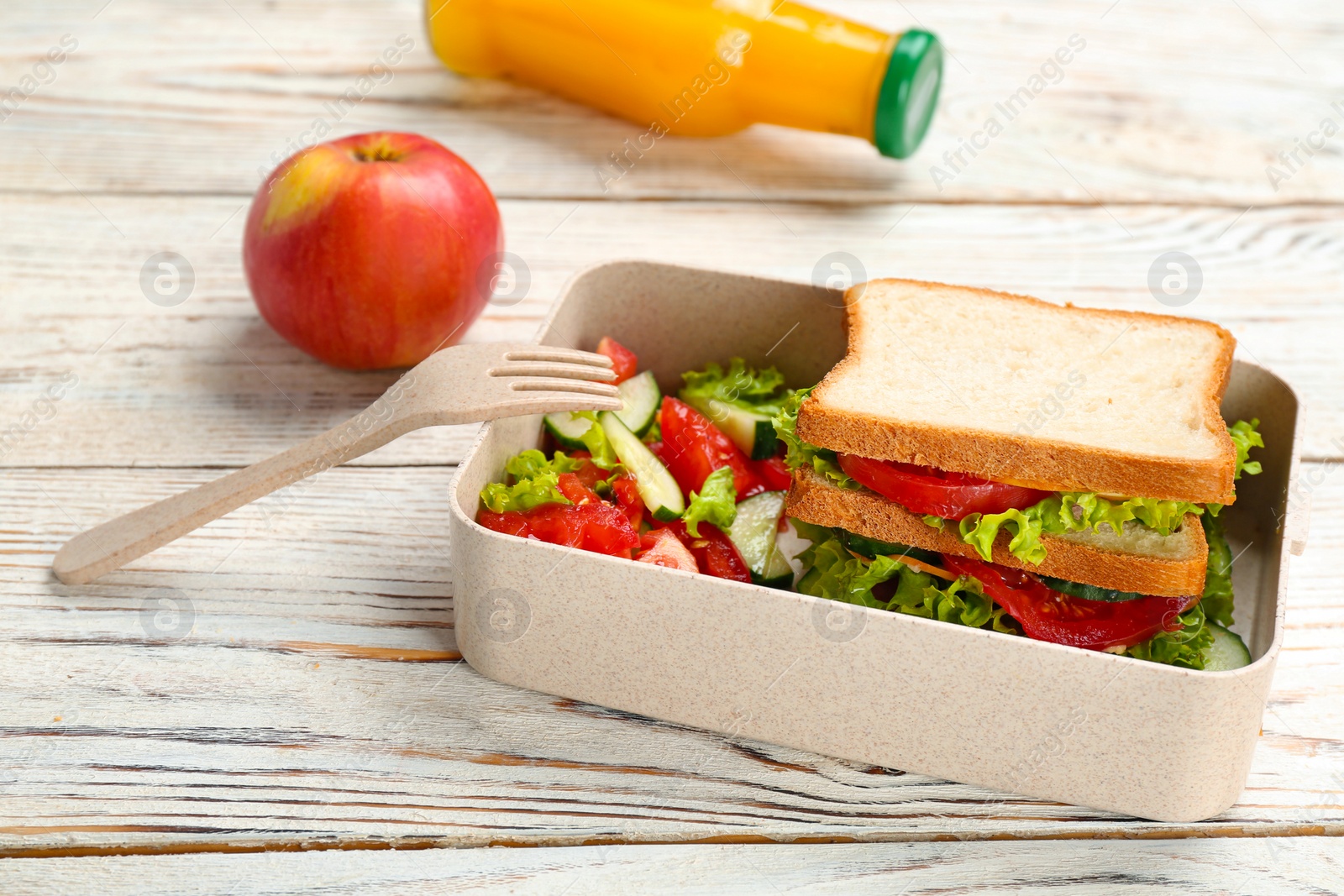 Photo of Lunch box with appetizing food on wooden table