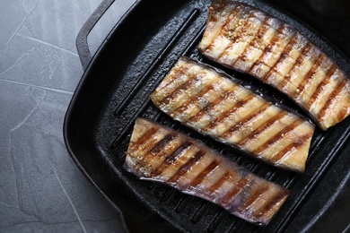 Photo of Delicious grilled eggplant slices in pan on grey table, top view